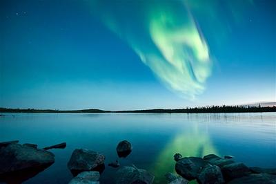 An-auroral-display-dominates-the-sky-over-Tibbitt-Lake-in-Canadas-Northwest-Territories-.jpg